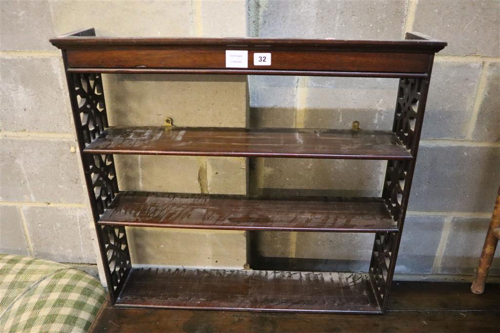 A George III style mahogany three shelf wall bracket, width 74cm, depth 16cm, height 67cm